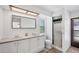 Well-lit bathroom with a shower, dual sinks, and a toilet with modern fixtures at 18585 Klingler Cir, Port Charlotte, FL 33948