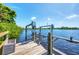 Waterfront dock with boat lift on a sunny day, offering direct access to the open water at 18585 Klingler Cir, Port Charlotte, FL 33948