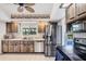 Kitchen featuring wood-look cabinets, stainless steel appliances, and tile flooring at 18585 Klingler Cir, Port Charlotte, FL 33948