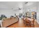 Open-concept living room with hardwood floors, kitchen, stainless steel appliances and dining area at 18585 Klingler Cir, Port Charlotte, FL 33948