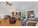 Bright living room with hardwood floors, large windows, comfortable seating, and a dining table at 18585 Klingler Cir, Port Charlotte, FL 33948
