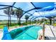 Sparkling pool in screened enclosure with water views and outdoor seating at 18585 Klingler Cir, Port Charlotte, FL 33948