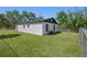 A backyard with grassy lawn and partial fence at 2101 W Cherry St, Tampa, FL 33607