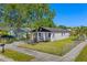Charming home featuring a landscaped front yard, fresh white paint, and a welcoming porch at 2101 W Cherry St, Tampa, FL 33607