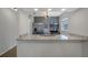 Modern kitchen with granite counters, stainless steel appliances, gray cabinets, and a stylish light fixture at 2101 W Cherry St, Tampa, FL 33607