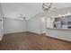 Open-concept living room featuring hardwood floors, modern lighting, and view of the kitchen at 2101 W Cherry St, Tampa, FL 33607