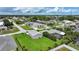 Suburban neighborhood featuring well-manicured lawns, mature trees, and homes with screened pools at 23493 Taber Ave, Port Charlotte, FL 33954