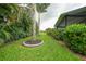 Beautiful backyard with a manicured lawn and view of the screened patio at 23493 Taber Ave, Port Charlotte, FL 33954