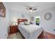 Bedroom features hardwood floors, neutral paint, a ceiling fan, and private access to the backyard at 23493 Taber Ave, Port Charlotte, FL 33954