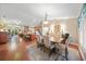 Open-concept dining room connected to a spacious kitchen and living area, with hardwood floors at 23493 Taber Ave, Port Charlotte, FL 33954