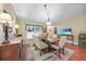 Well lit dining room with wood floors, matching wooden furniture, and light walls at 23493 Taber Ave, Port Charlotte, FL 33954