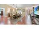 Open dining room with wood floors, light walls, neutral decor, and lots of natural light at 23493 Taber Ave, Port Charlotte, FL 33954