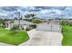 Well-maintained single Gathering home featuring a two-car garage and spacious concrete driveway at 23493 Taber Ave, Port Charlotte, FL 33954