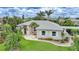 Inviting single Gathering home with lush landscaping, light exterior, and beautiful curb appeal at 23493 Taber Ave, Port Charlotte, FL 33954