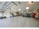 Garage featuring high ceilings, epoxy floor, ample storage, and workspace at 23493 Taber Ave, Port Charlotte, FL 33954
