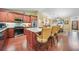 Open kitchen with seating at the kitchen island, stainless steel appliances, and hardwood floors at 23493 Taber Ave, Port Charlotte, FL 33954