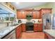 Kitchen with granite countertops, stainless steel appliances, tile backsplash, and hardwood floors at 23493 Taber Ave, Port Charlotte, FL 33954