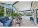 Relax on the covered lanai with comfortable seating overlooking the pool and lush landscaping at 23493 Taber Ave, Port Charlotte, FL 33954