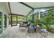 Relax on the covered lanai with comfortable seating overlooking the lush landscaping at 23493 Taber Ave, Port Charlotte, FL 33954