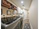 Modern laundry room with front load washer and dryer, wood shelves, and a utility sink at 23493 Taber Ave, Port Charlotte, FL 33954