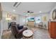 Cozy living room with a leather recliner, tile floors, a ceiling fan, and plenty of natural light at 23493 Taber Ave, Port Charlotte, FL 33954