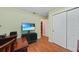 Office or flex room with wood floors, tv, and storage, ideal for a home office or media room at 23493 Taber Ave, Port Charlotte, FL 33954