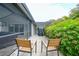Enjoy the outdoor patio area with seating and view of the lush landscaping at 23493 Taber Ave, Port Charlotte, FL 33954