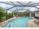 Enjoy the private screened pool surrounded by brick pavers and lush landscaping at 23493 Taber Ave, Port Charlotte, FL 33954