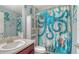 Charming bathroom featuring coastal decor, a stylish vanity, and a themed shower curtain creating a unique space at 237 Strasburg Dr, Port Charlotte, FL 33954