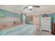 Bedroom with ceiling fan and coastal decor accents; view of walk-in closet at 237 Strasburg Dr, Port Charlotte, FL 33954