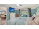 Bedroom featuring ceiling fan, coastal decor, and view of patio and outdoor pool at 237 Strasburg Dr, Port Charlotte, FL 33954