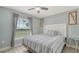Comfortable bedroom offers a well-lit window and a ceiling fan providing a relaxing and inviting atmosphere at 237 Strasburg Dr, Port Charlotte, FL 33954