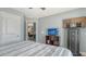 Bedroom showcasing a stylish accent wall with mounted television, providing a cozy and functional space at 237 Strasburg Dr, Port Charlotte, FL 33954