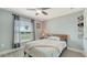 Bright bedroom featuring a ceiling fan, large window and wood-look floors, creating a calming retreat at 237 Strasburg Dr, Port Charlotte, FL 33954