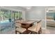 Dining area with table, chairs, and sliding glass doors leading to outdoor seating and pool at 237 Strasburg Dr, Port Charlotte, FL 33954