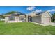Charming single Gathering home featuring a large front yard, solar panels, and neutral stucco exterior at 237 Strasburg Dr, Port Charlotte, FL 33954