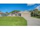 Charming single-Gathering home boasts solar panels, a two-car garage, and a lush front lawn at 237 Strasburg Dr, Port Charlotte, FL 33954
