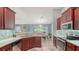Well-lit kitchen featuring stainless steel appliances, rich wood cabinetry, and tile backsplash at 237 Strasburg Dr, Port Charlotte, FL 33954