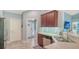 Bright kitchen showcasing stainless steel appliances, cabinetry, and tile flooring leading to foyer at 237 Strasburg Dr, Port Charlotte, FL 33954