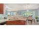Kitchen with wood cabinets, stainless steel dishwasher, and view into dining area at 237 Strasburg Dr, Port Charlotte, FL 33954