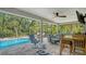 This covered patio offers a view of the pool, backyard and comfortable outdoor seating at 237 Strasburg Dr, Port Charlotte, FL 33954