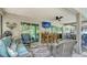 This covered patio features comfortable seating, dining area, and a mounted television at 237 Strasburg Dr, Port Charlotte, FL 33954