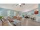 Open-concept living space with kitchen access, comfortable seating, and seamless indoor-outdoor flow at 237 Strasburg Dr, Port Charlotte, FL 33954