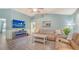 Open-concept living room features modern flooring, an entertainment center, and comfortable seating at 237 Strasburg Dr, Port Charlotte, FL 33954