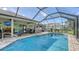 The backyard has a screened in pool, hot tub, and outdoor grilling area at 237 Strasburg Dr, Port Charlotte, FL 33954