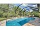 This screened pool offers a beautiful space for relaxing and enjoying the outdoors at 237 Strasburg Dr, Port Charlotte, FL 33954