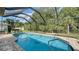 The screened-in backyard features a large pool and grassy area, perfect for outdoor entertaining at 237 Strasburg Dr, Port Charlotte, FL 33954