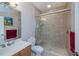 Bathroom featuring a tiled walk-in shower, vanity, toilet, and decoratively painted walls at 2387 Nuremberg Blvd, Punta Gorda, FL 33983