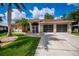 Well-maintained home with a tile roof, a two-car garage, and a beautifully landscaped front yard at 2387 Nuremberg Blvd, Punta Gorda, FL 33983