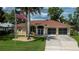 Beautiful single-story home with a well-manicured lawn, tile roof, and American flag at 2387 Nuremberg Blvd, Punta Gorda, FL 33983